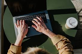 "Person typing on a laptop keyboard, working or studying"